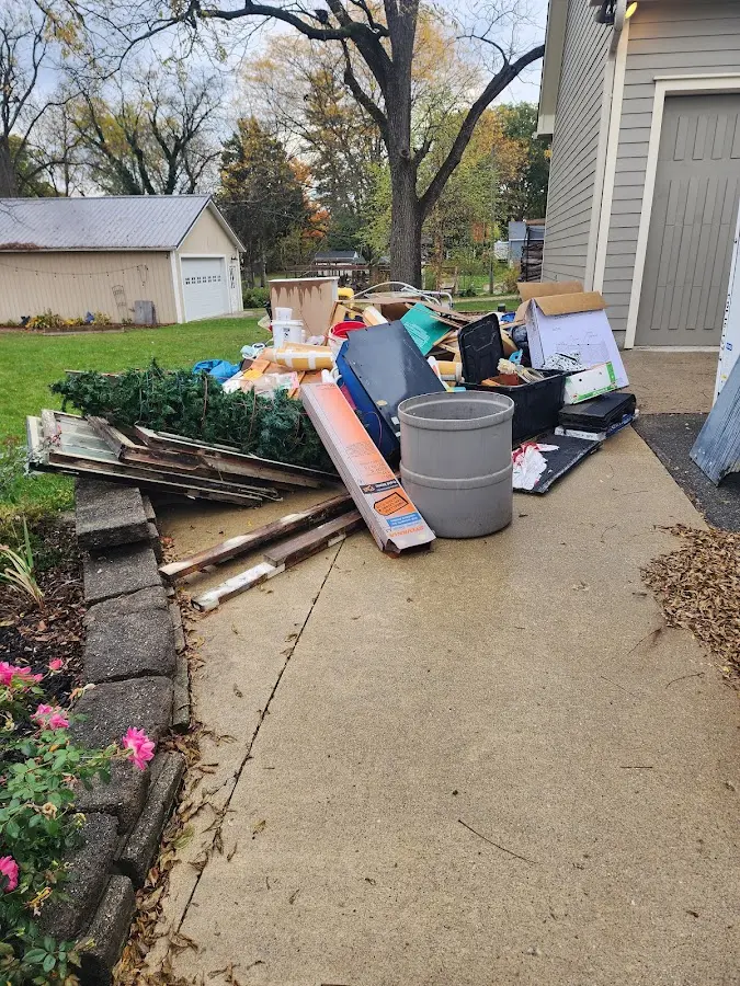 Dumpster being loaded with debris for Estate Cleanout Dumpster Rental in Bunk Foss